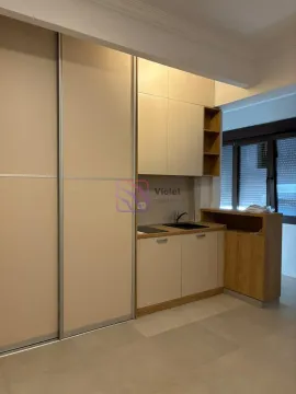 Small kitchen with built-in units and a large wardrobe next to it. - image 3