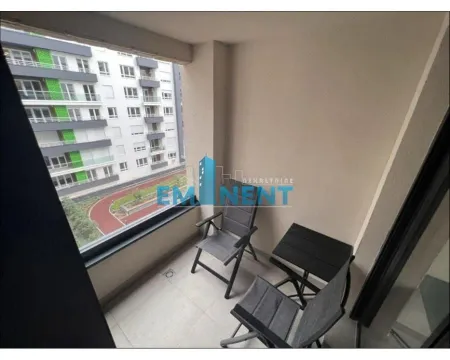 Covered balcony with a table and chairs and a view of surrounding buildings. - image 9