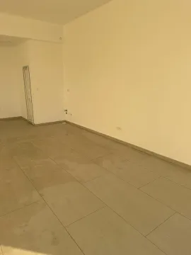 Empty room with ceramic floor tiles and light-colored walls. - image 2