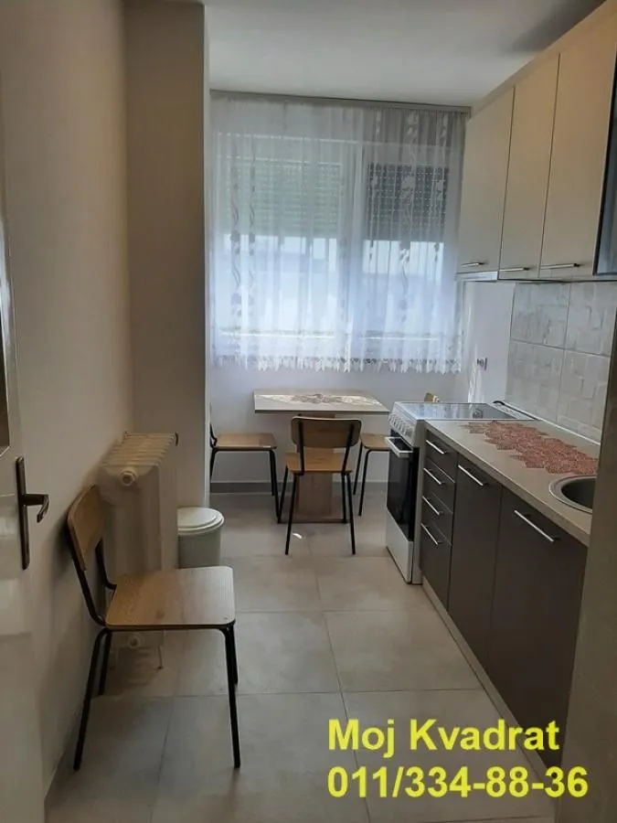 Smaller kitchen with a dining table and window.