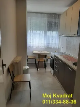 Smaller kitchen with a dining table and window. - image 4