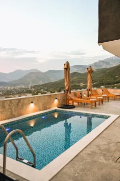 Terrace with a swimming pool and sun loungers overlooking the mountains. - image 4