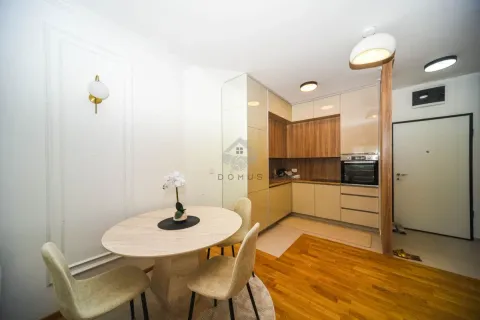 Modern kitchen with dining area and built-in appliances. - image 5