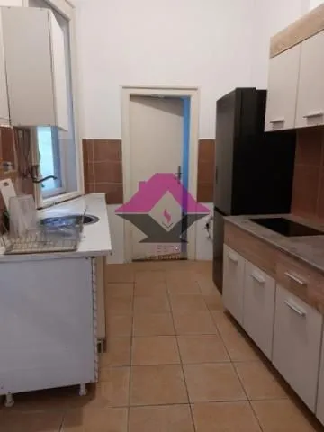 Small kitchen with cabinets and a refrigerator.