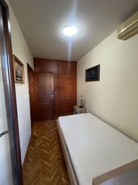 A small bedroom featuring a single bed and a wooden wardrobe. - image 26