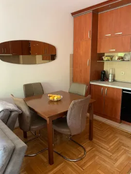 Dining area with a dining table and chairs next to the kitchen. - image 2