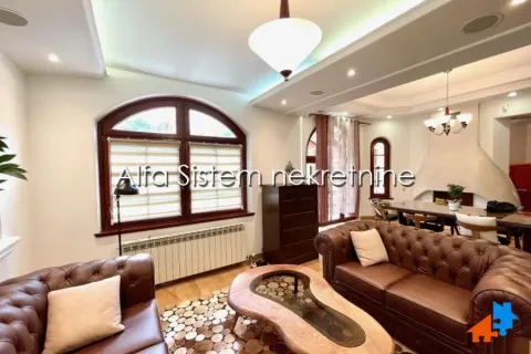 Spacious living room with leather sofas and a dining area in the background. - image 4