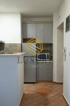 Smaller kitchen with grey cabinets and tiled floor. - image 11