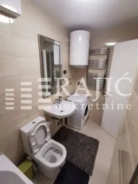 Smaller bathroom with sanitary ware, shower, and washing machine. - image 4