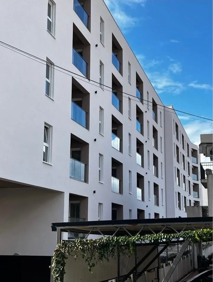 Exterior of a modern residential building with balconies.