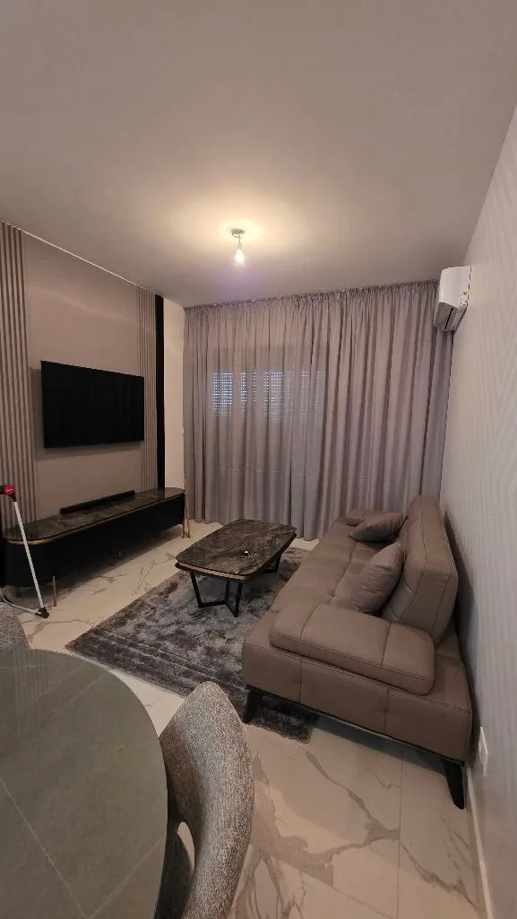 Modern and tidy living room with a sofa and television.