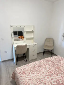Bedroom with a double bed and a vanity desk with a mirror. - image 6