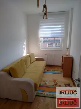 Manja dnevna soba sa žutim trosedom i tepihom sa dezenom životinja. - image 9