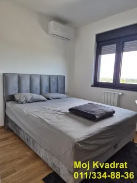 Bedroom with a double bed, air conditioning unit, and a window. - image 8
