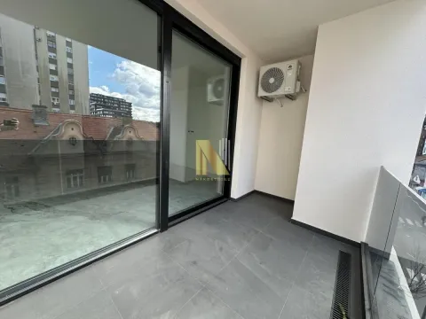 Spacious terrace with a view of surrounding buildings and the city. - image 10