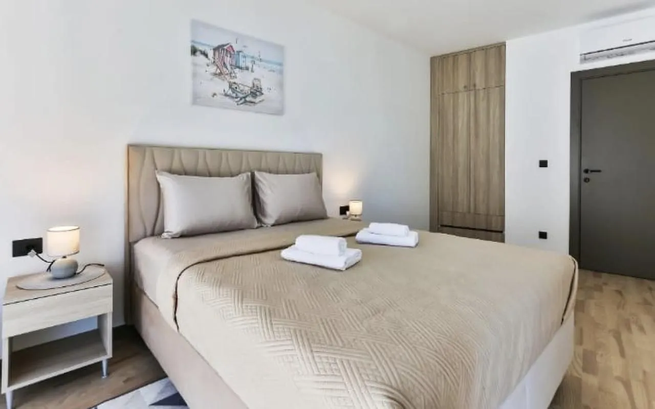 Bedroom with a double bed, bedside tables, and a built-in wardrobe.