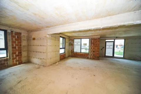 Unfinished commercial space in grey phase with concrete floors and walls. - image 4