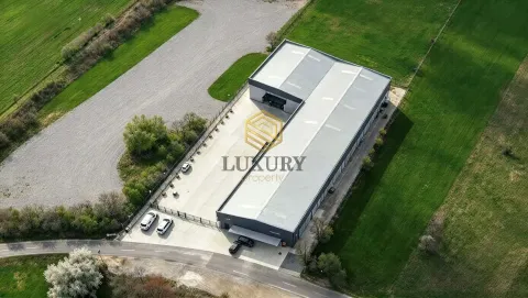 Aerial view of a commercial building with an associated yard and parking lot. - image 2