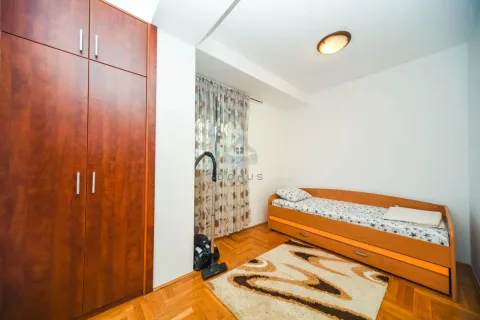 Small bedroom with a bed, wooden wardrobe, and parquet flooring. - image 8
