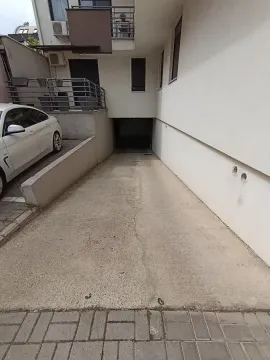 Entrance ramp to the underground garage of the building with a parking space. - image 3