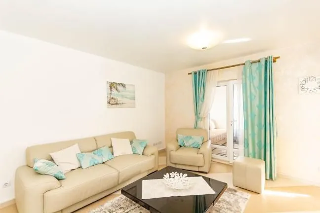 Bright living room with sofa set and terrace access.