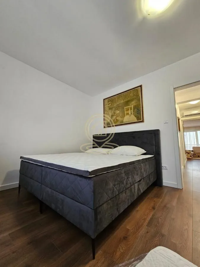 Bedroom with a double bed and a painting on the wall.