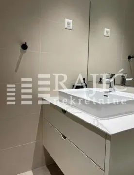 Modern bathroom with a sink and mirror. - image 9