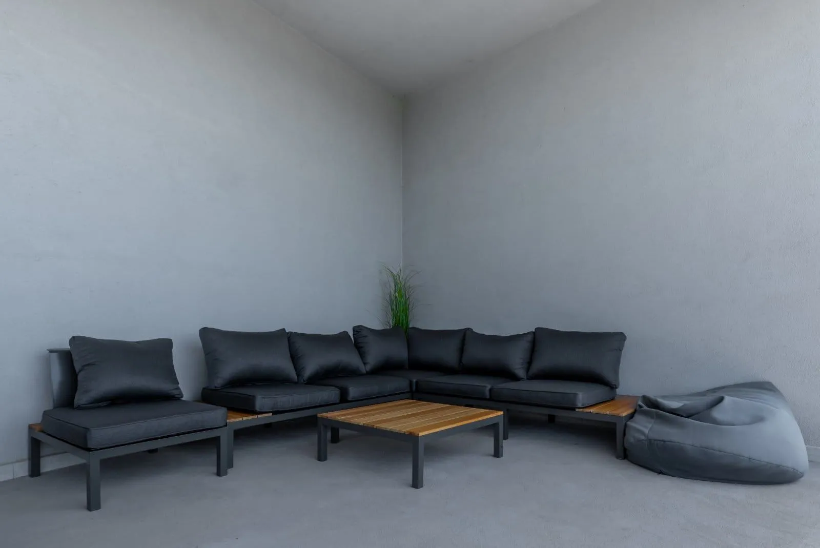 Terrace with dark built-in sofa set and a wooden coffee table.