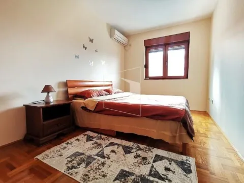 Furnished bedroom with a double bed, bedside table, and a rug. - image 8