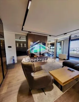 Modern living room with a sofa set, armchair, and TV. - image 9