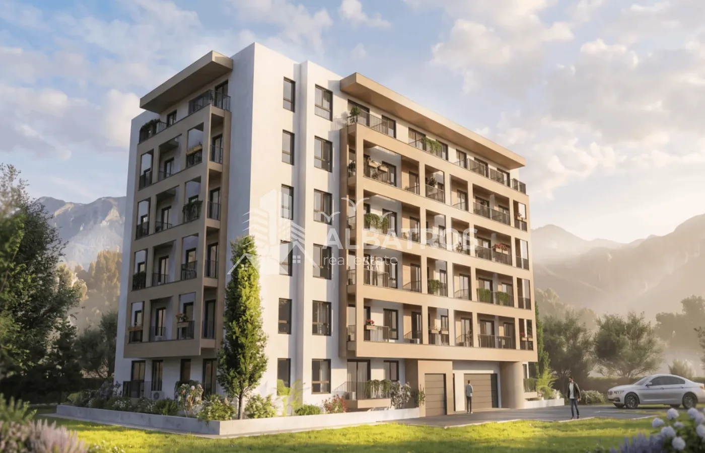 Exterior view of a modern residential building with balconies and landscaped surroundings.