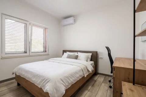 Svijetla spavaća soba sa bračnim krevetom, radnim stolom i klima uređajem. - image 6