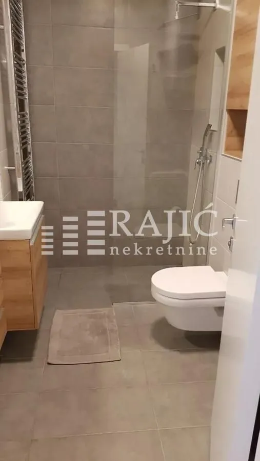 Modern equipped bathroom with a walk-in shower.