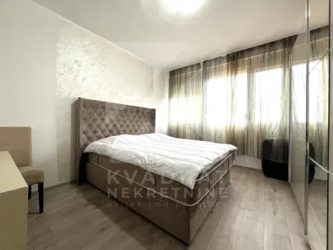 Bedroom with a double bed, wardrobe, and a window with curtains. - image 6