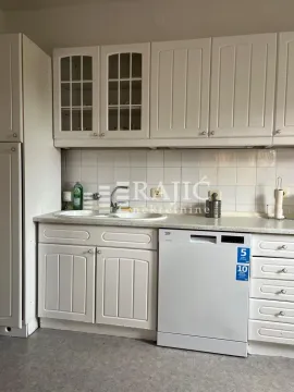White kitchen with a sink and built-in units. - image 11