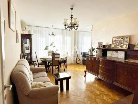 Spacious living room with a dining area and parquet flooring. - image 2