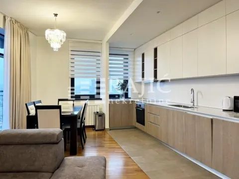 Modern kitchen with dining area and living room in light tones. - image 3
