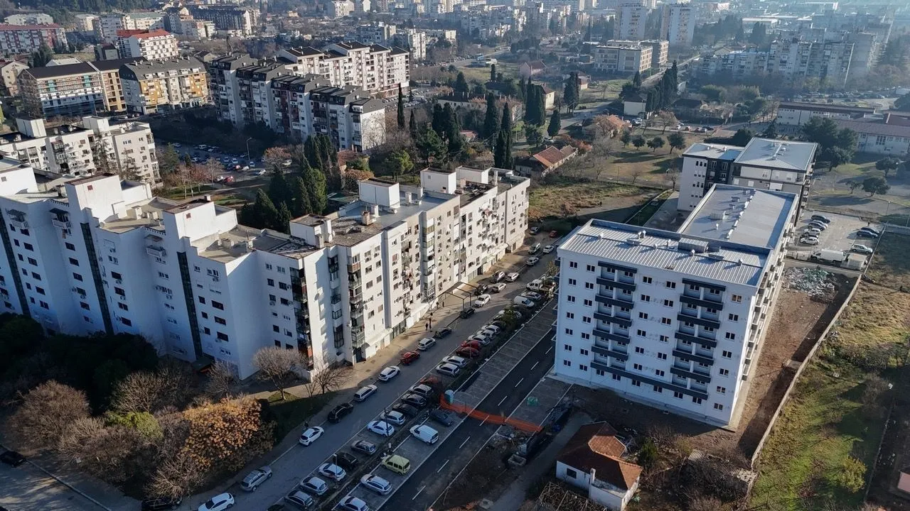 Aerial view of residential buildings and the surrounding neighborhood.