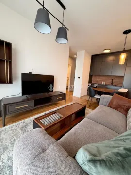 Living room connected to the dining area and kitchen in a modern apartment. - image 2