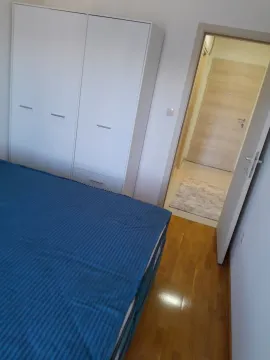 Furnished bedroom with a bed and wardrobe. - image 6