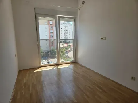 Empty room with hardwood floors and balcony doors. - image 2