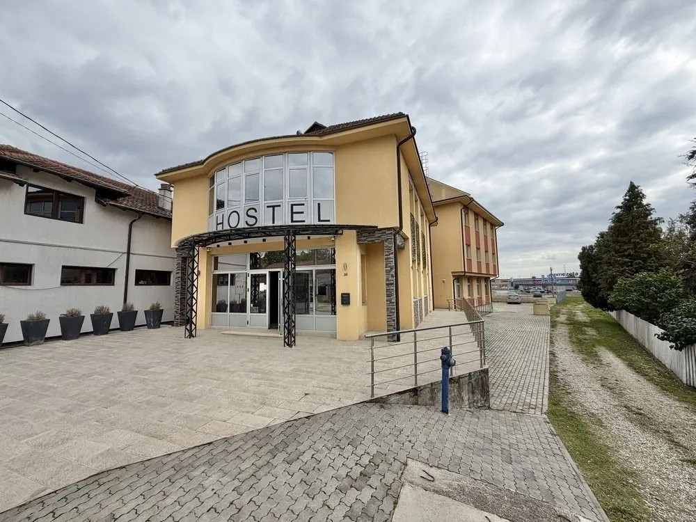 Exterior of the commercial building with a hostel sign at the entrance.