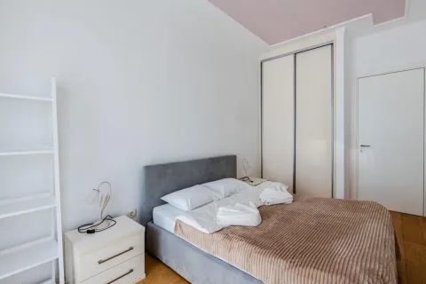 Bright and tidy bedroom with a double bed, wardrobe, and bedside table. - image 8