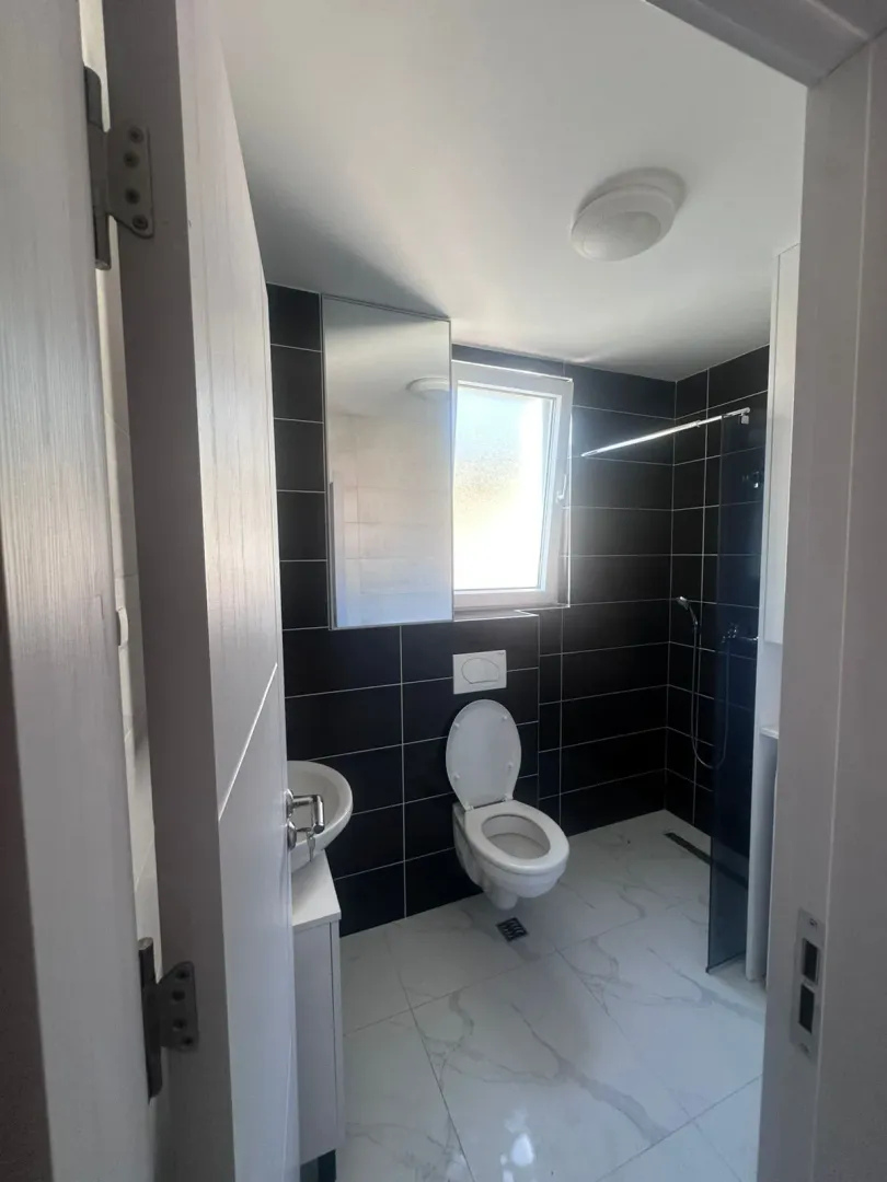 Modernly equipped bathroom with a walk-in shower.