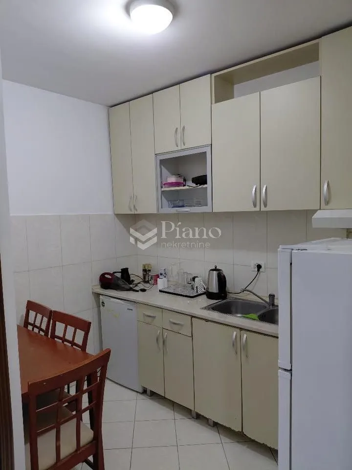 Small kitchen with a dining table and chairs.