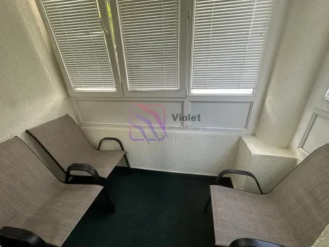 Enclosed balcony with three armchairs and window blinds. - image 4