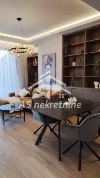Living room with a dining area and modern furniture. - image 6