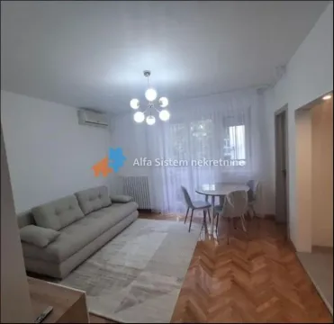Living room with a sofa and a dining table. - image 11