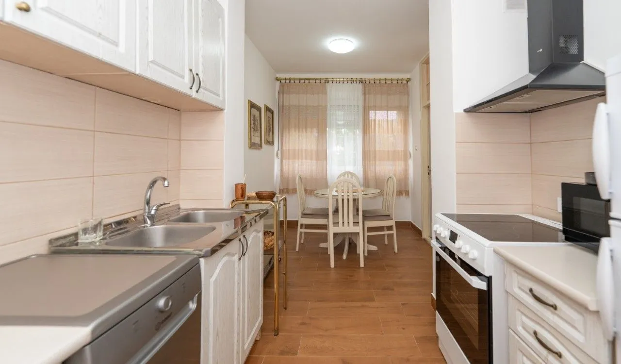 Kitchen with a dining area and fitted cabinets.