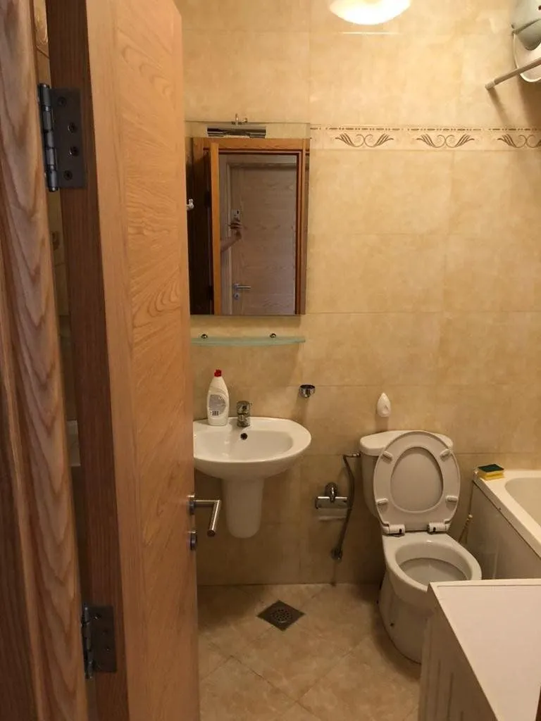 Small bathroom with a sink, toilet, and bathtub.